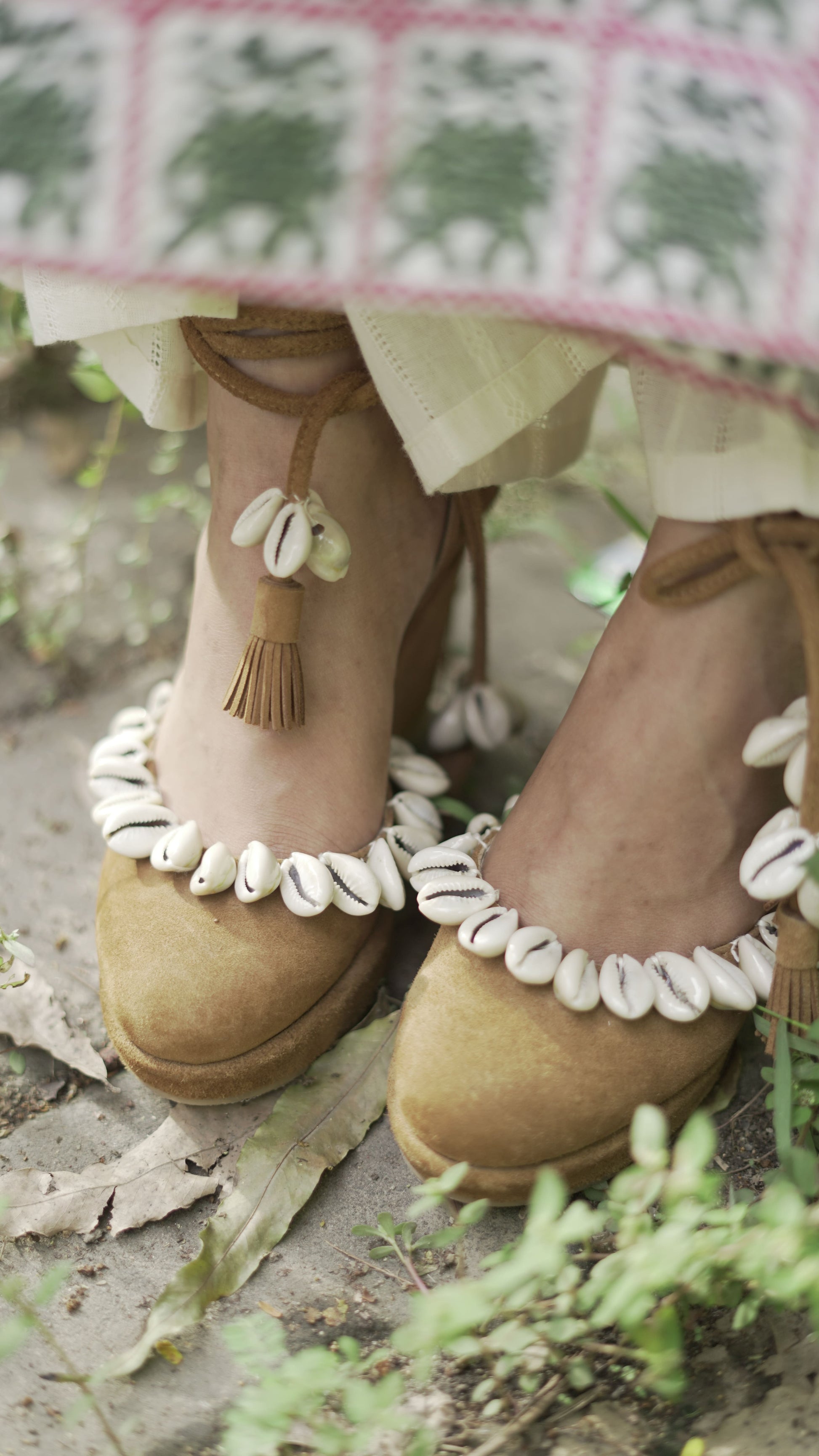 Photo of Beige suede pumps (heels) with ankle strap and sea shell detailings.